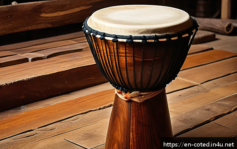 코트디부아르 젬베 드럼 문화 - A detailed close-up of a traditional West African djembe drum handcrafted from a single piece of den...